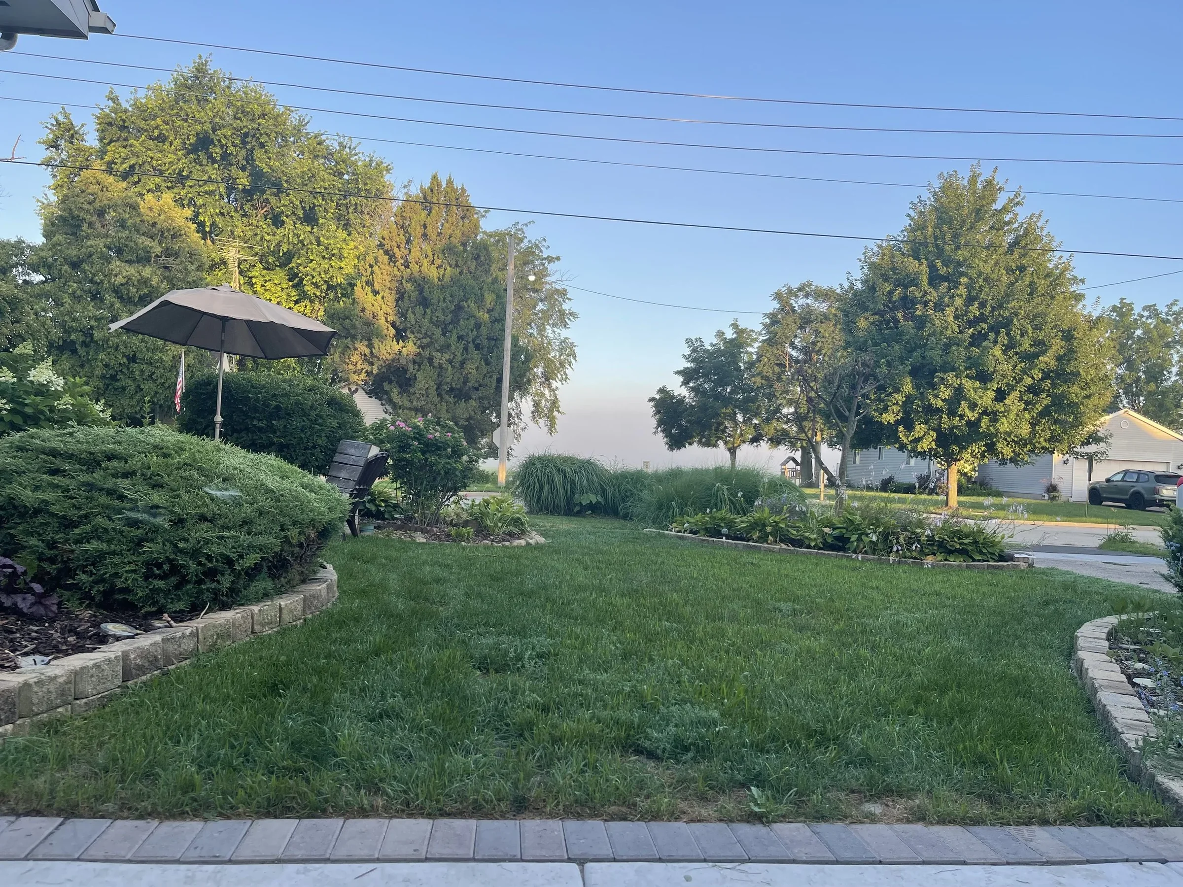 Landscaped lawn and planting beds maintained by Panther Landscape in Harvard, Illinois